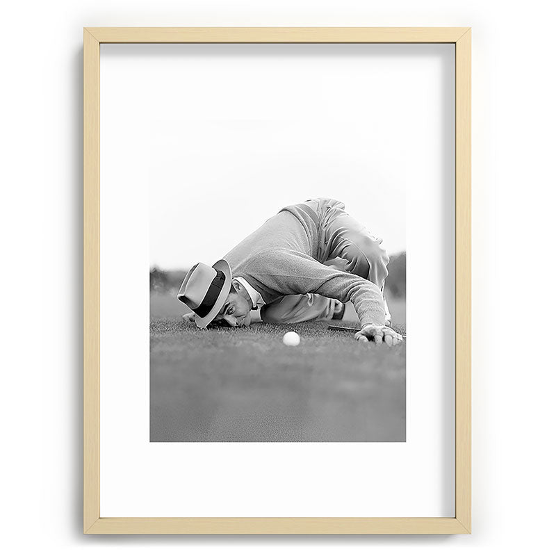 Eye to the ground on the 18th hole; golfing man eyes ball to measure distance to hole vintage black and white portrait photograph - photography - photographs poster Framed Art Print Gallery Image 100